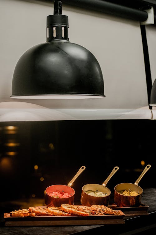 Toasted Bread and Pans with Different Toppings on the Table 