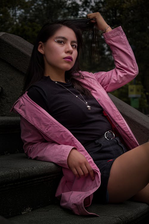 Model Posing in Shorts and Pink Jacket