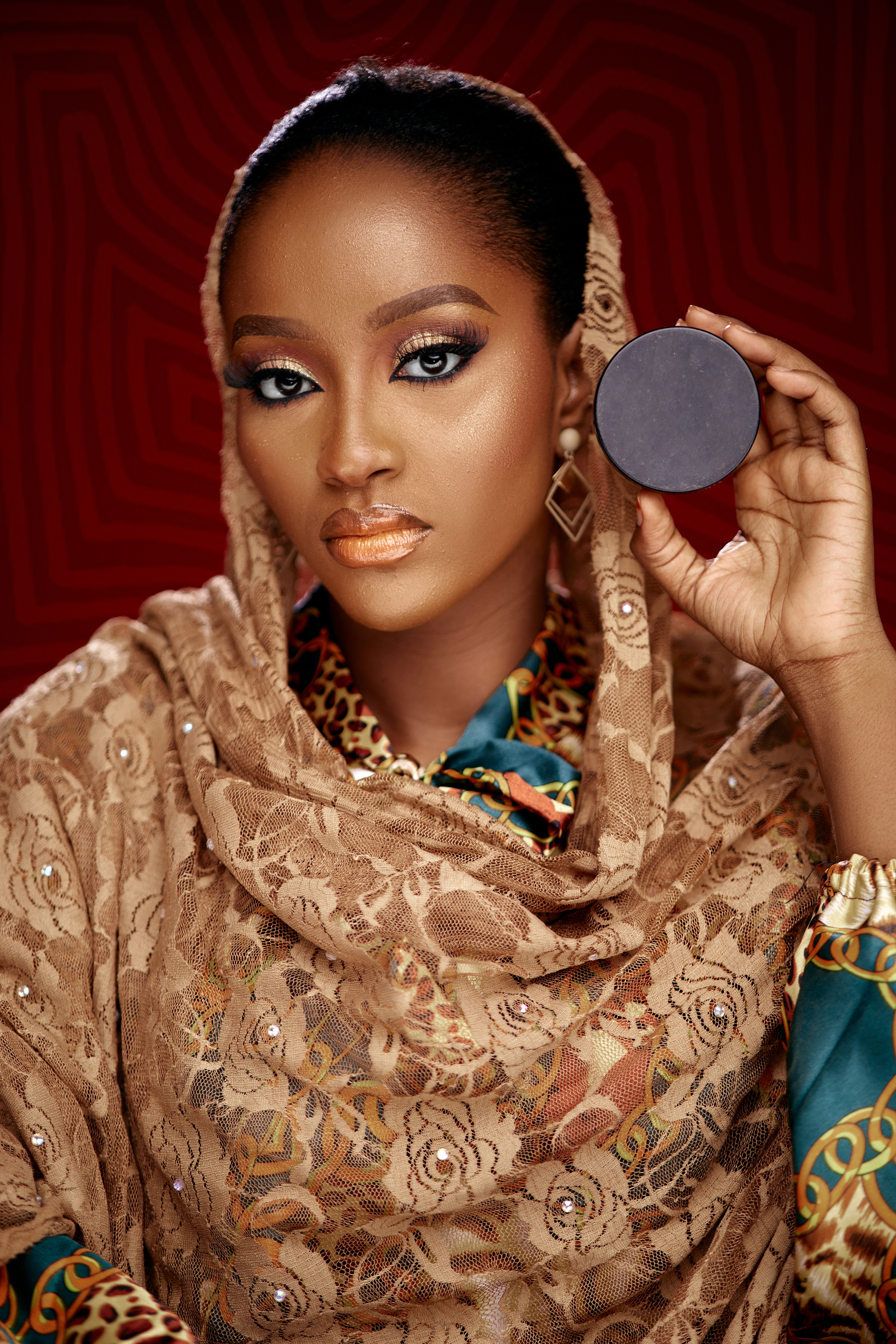 Striking portrait of a woman showcasing fashion and makeup artistry.