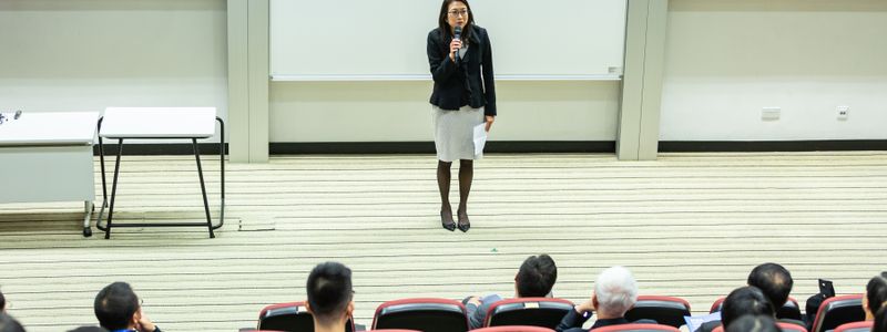 A speaker presenting to an audience in an auditorium