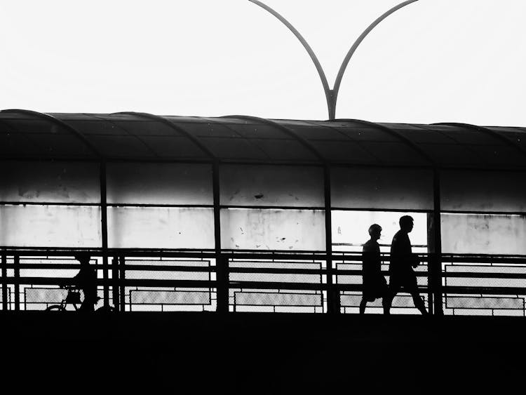 Silhouette Of People In Tunnel