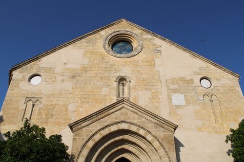 Free Sunlit facade of a historic church in Jerez de la Frontera, showcasing architectural elements and religious symbolism. Stock Photo