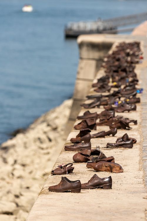 Free Bronze shoes memorial on the Danube River bank, honoring Holocaust victims in Budapest. Stock Photo