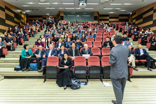 Man Standing In Front Of People 