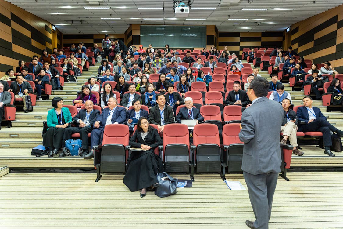 Man Standing In Front Of People 