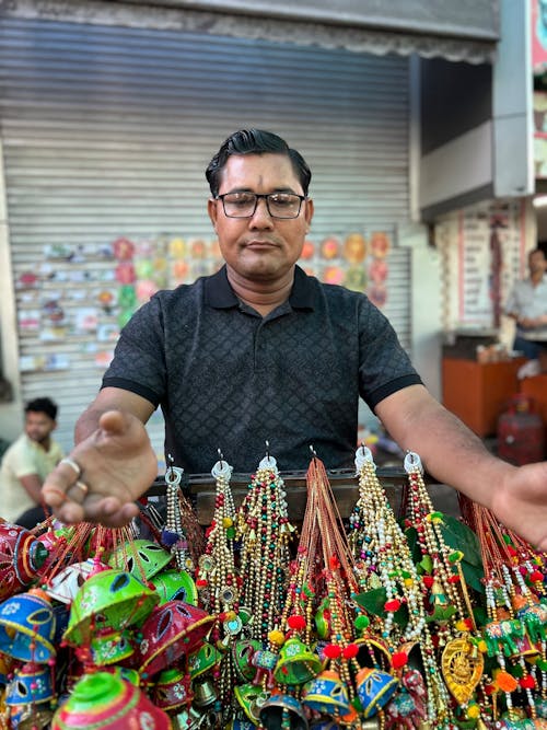 Man on Stand with Accessories on Street Market