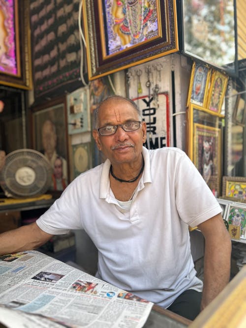 Man Sitting with Newspaper