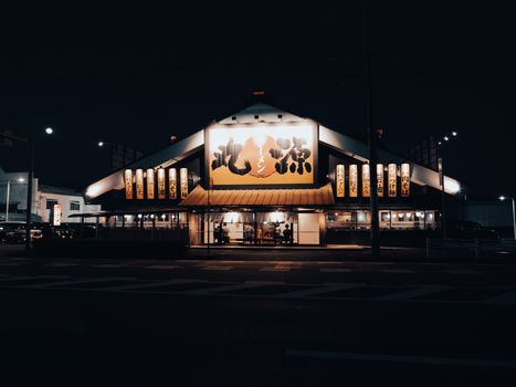 A traditional Japanese building glowing with lights at night in Toyohashi, Aichi, Japan.