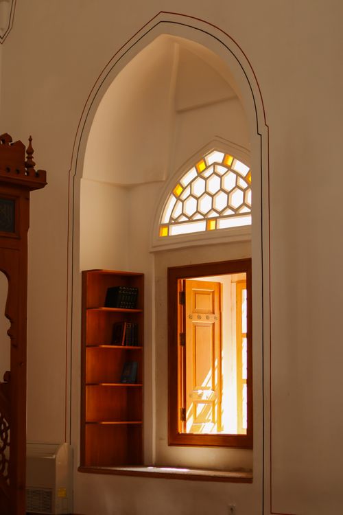Free Elegant arched window and bookshelf detail in an İstanbul interior. Stock Photo