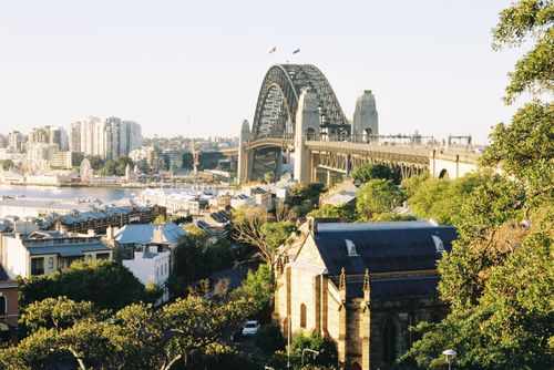 Free Panoramic view of Sydney Harbour Bridge with city skyline in the background. Stock Photo