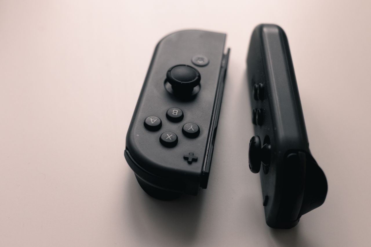 a close up image of two nintendo switch joy con controllers on a neutr