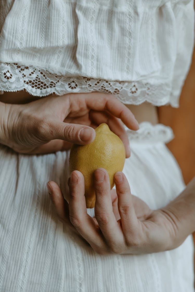 Hands Holding Lemon