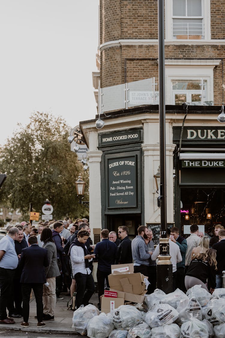 People Gathered In Front Of The Duke Of York Restaurant, London, UK