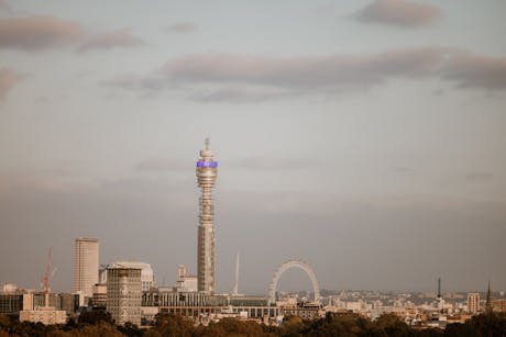 Capture of the London skyline featuring the iconic BT Tower and London Eye at dusk.