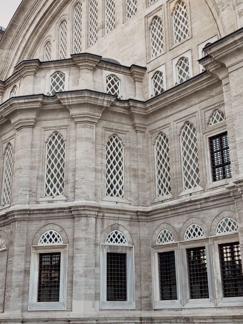 Free Detailed view of the Nuruosmaniye Mosque's Ottoman facade in Istanbul, showcasing intricate windows and stonework. Stock Photo