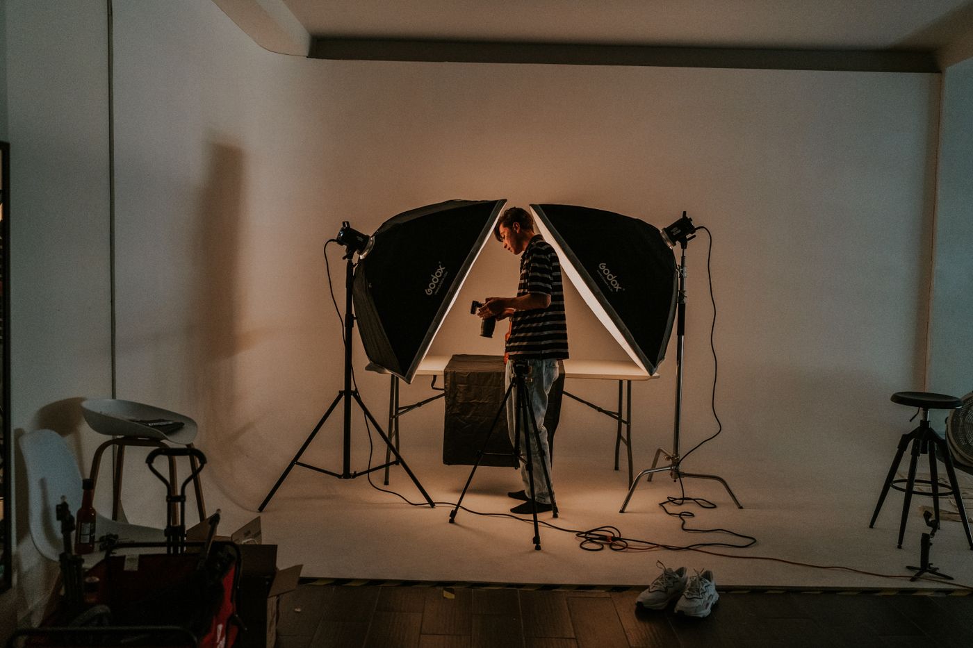 Photographer standing between studio lights