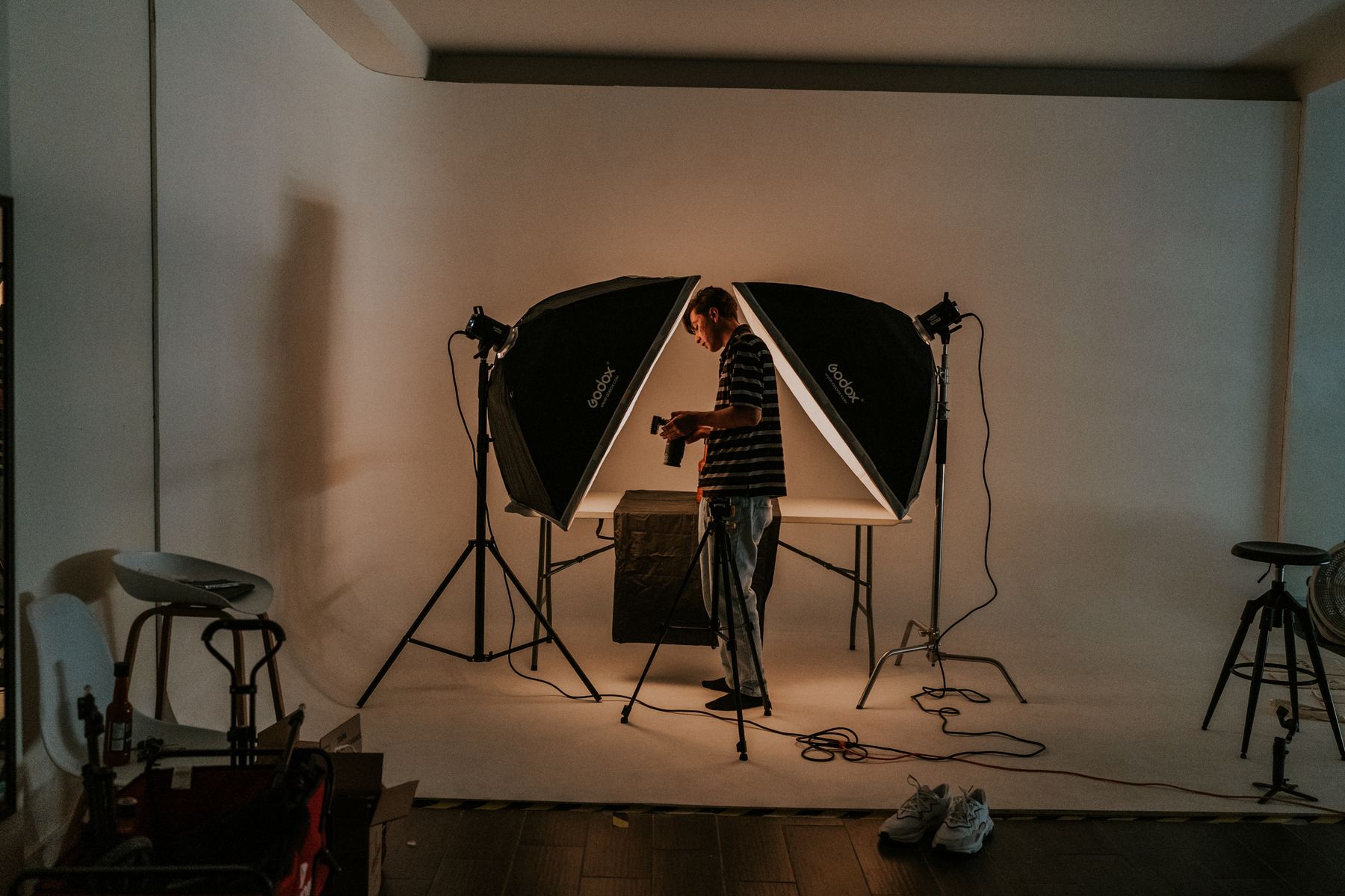 Photographer standing between studio lights