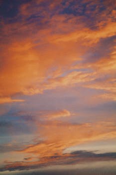 Beautiful orange clouds over Talgar, Kazakhstan during sunset, creating a dramatic sky backdrop.
