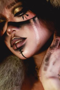 Stunning close-up of a model with unique artistic makeup and face painting.