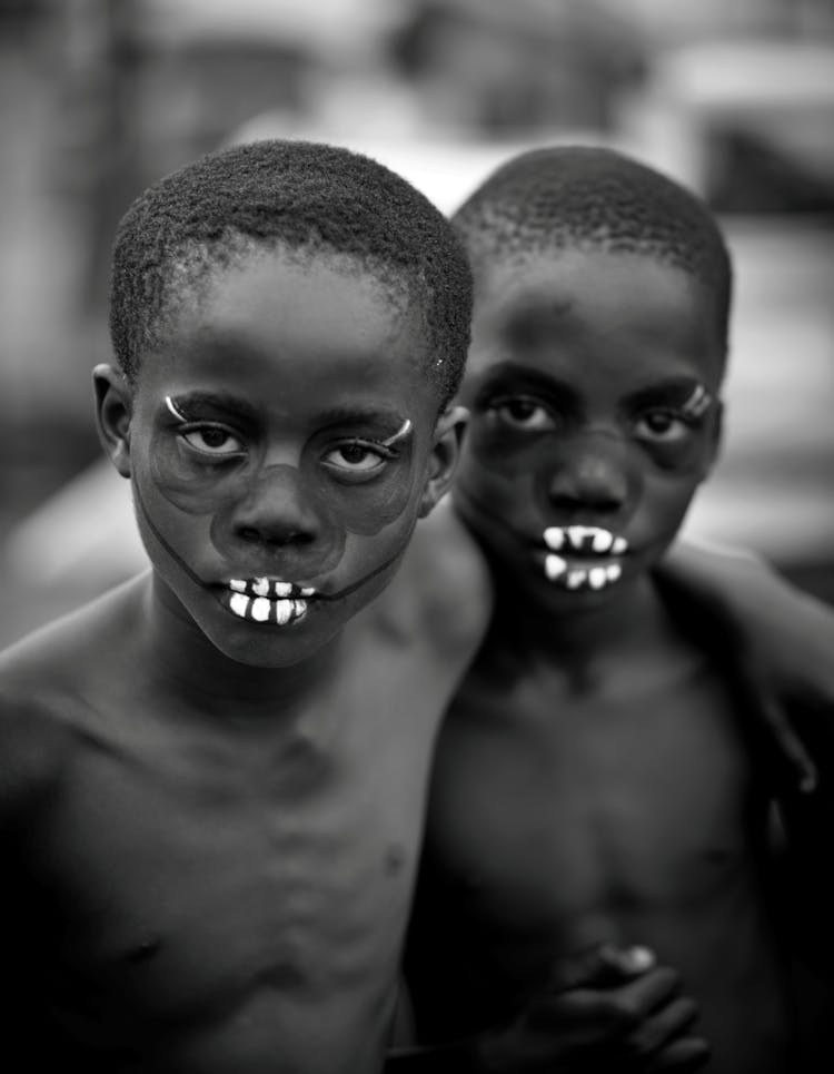 Portrait Of Two Shirtless Boys With Paint On Their Faces 