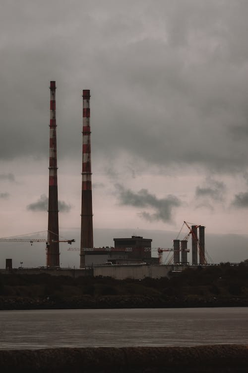 Factory with Industrial Chimneys Against the Cloudy Sky