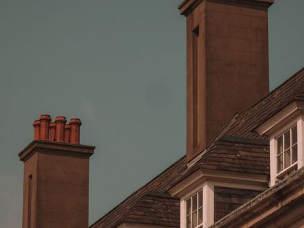 Metal chimney chase cover on top of a sided chimney chase