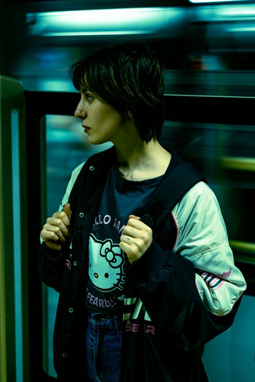 Free Stylish young woman in metro station, capturing urban movement and fashion. Stock Photo