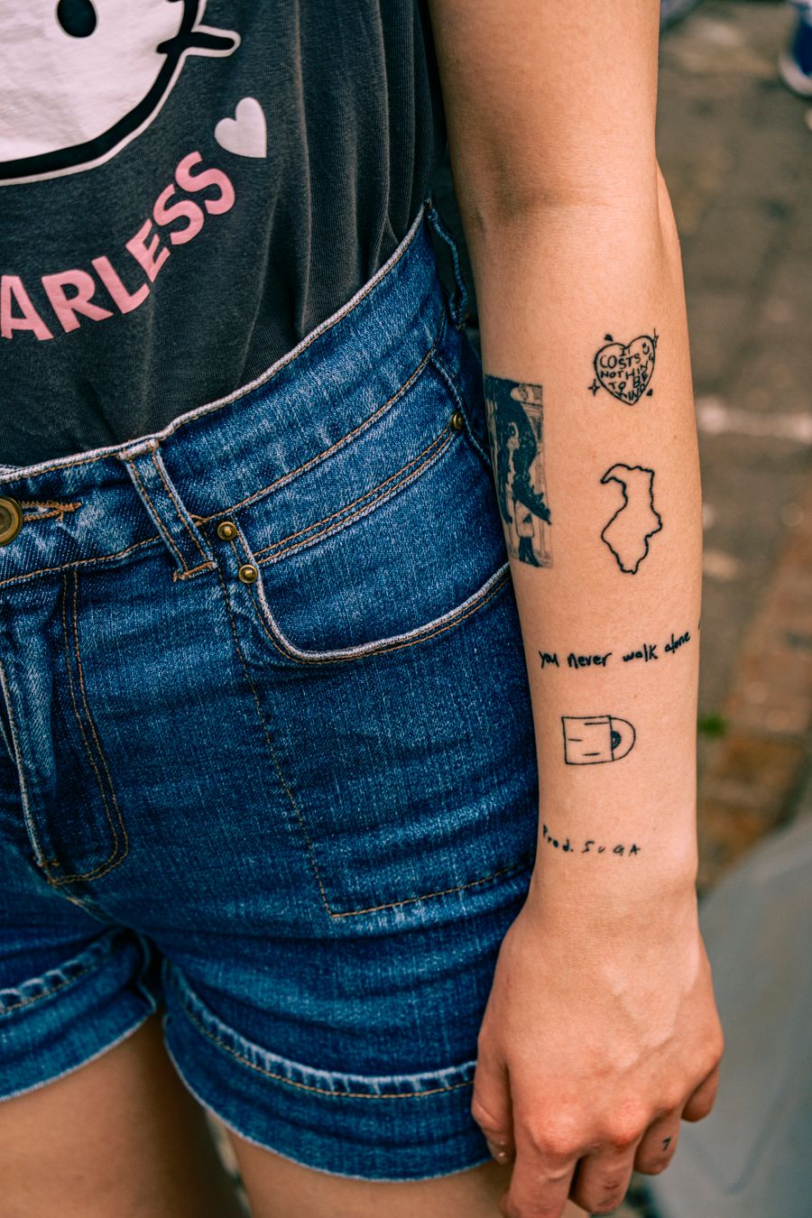 Minimalist line tattoos along the arm