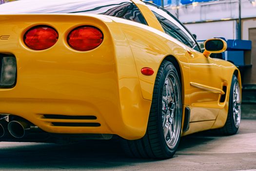 A yellow corvette car with a rear end