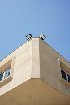 Low angle view of modern building corner against clear blue sky in Los Angeles.