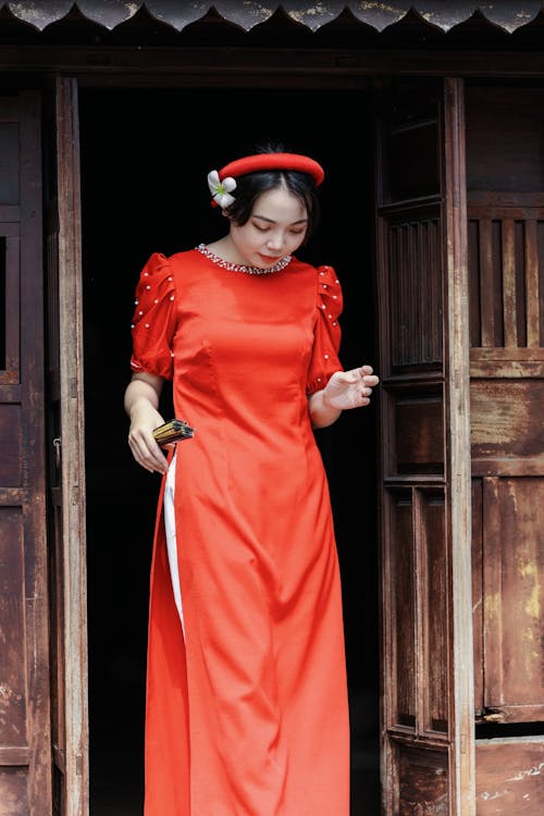 Woman in Traditional Dress Standing in Doorway