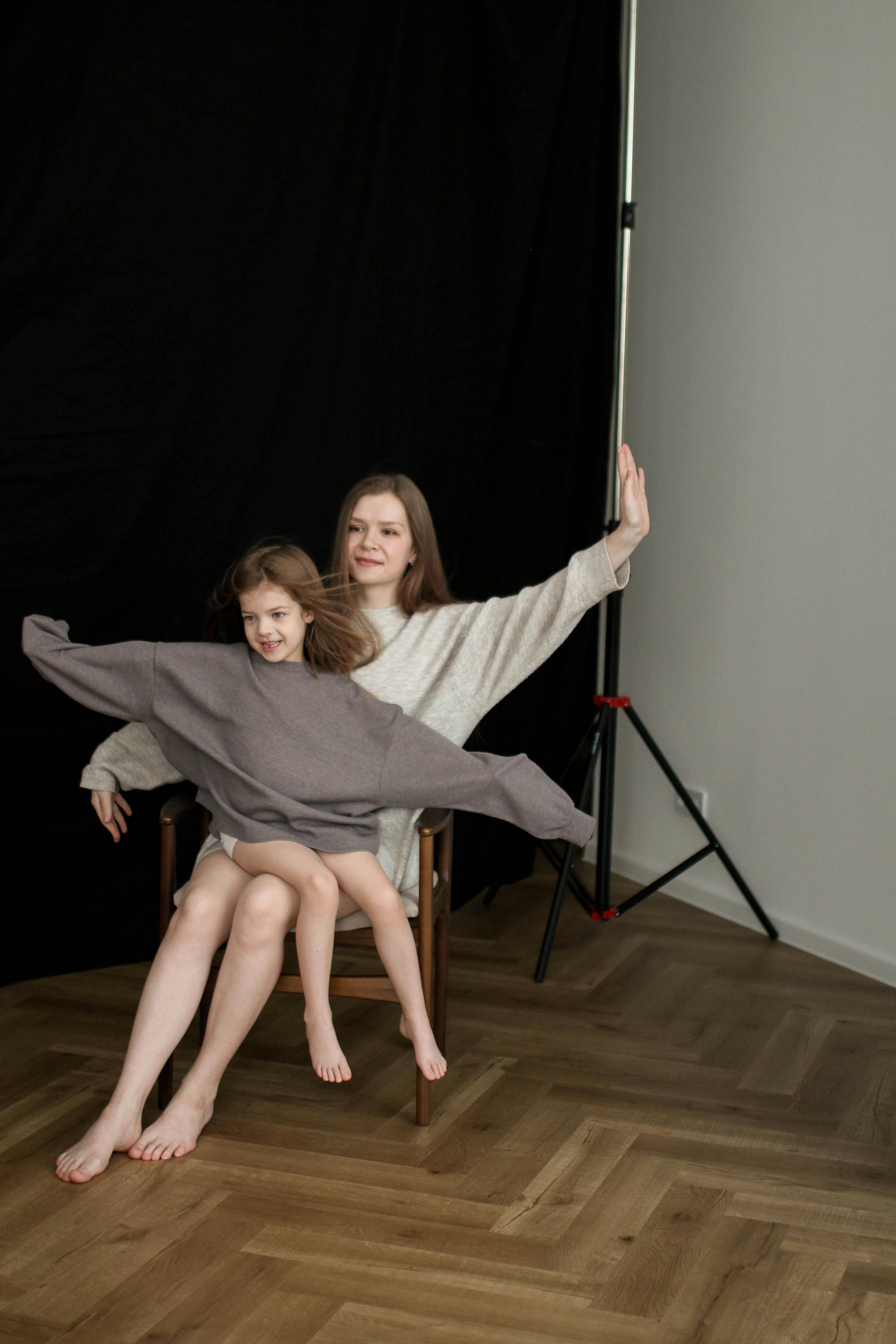 Barefoot Mother and Daughter Posing in Trench Coats · Free Stock Photo