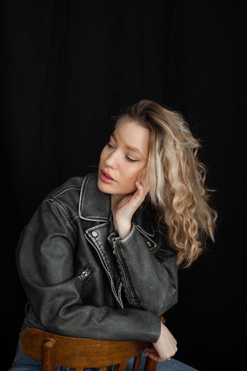 Studio Shot of a Young Woman in Jeans and a Leather Jacket