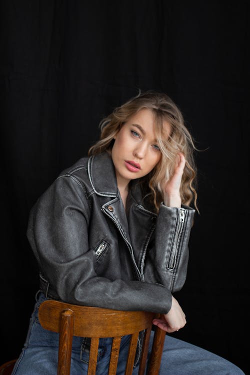 Studio Shot of a Young Woman in Jeans and a Leather Jacket