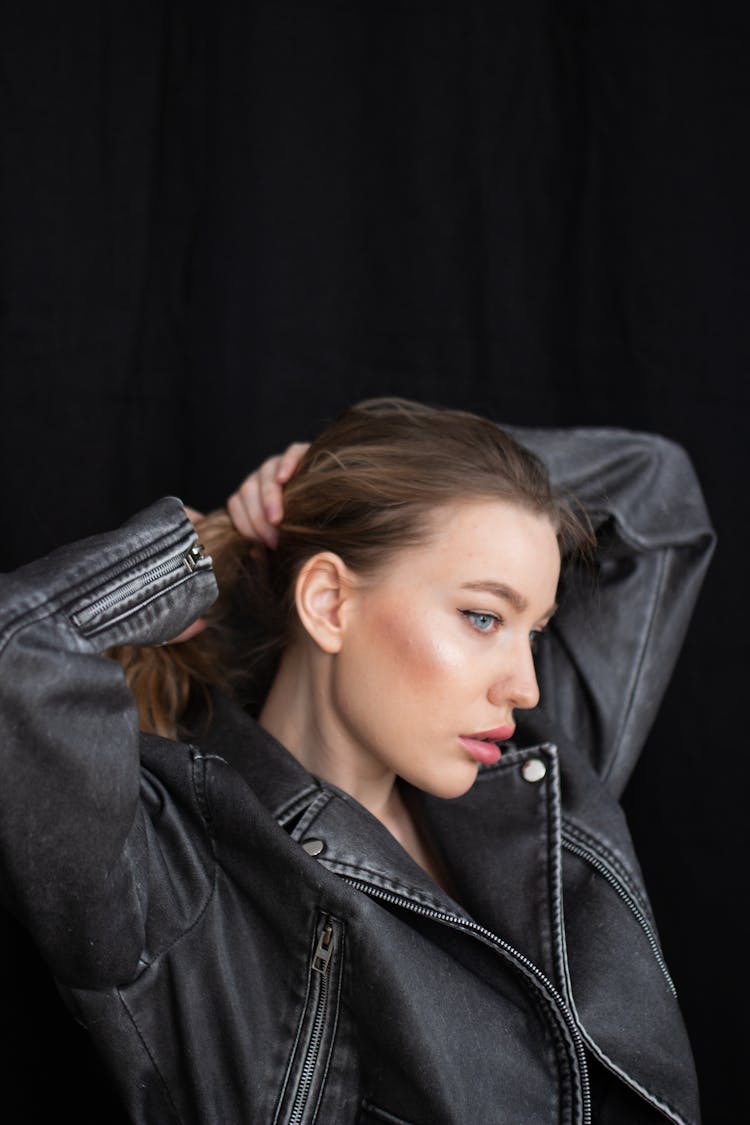 Woman In Biker Jacket Fixing Hair