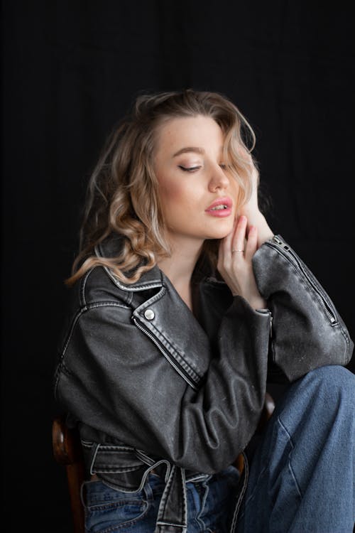 Studio Shot of a Young Woman in Jeans and a Leather Jacket