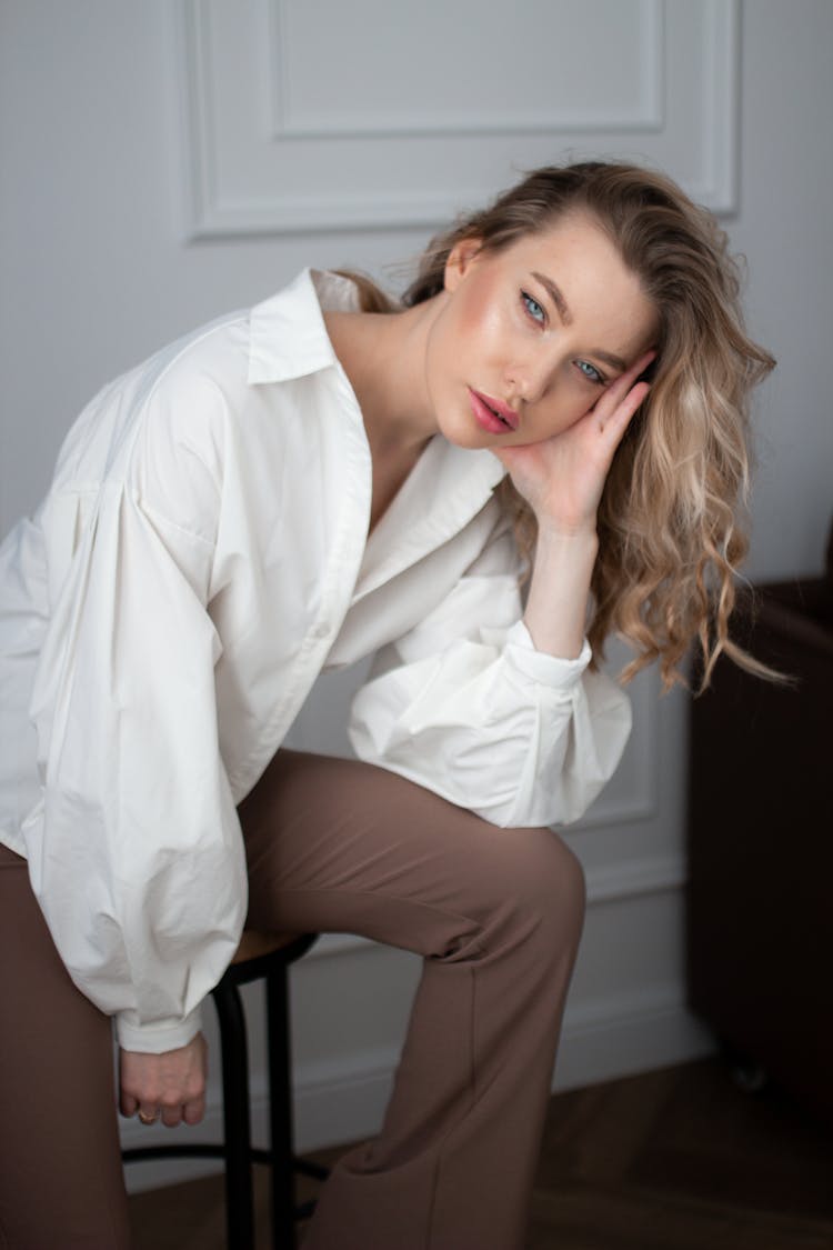 Young Woman Posing On Stool In Studio