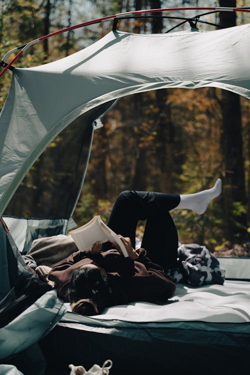 Woman Lying in a Tent and Reading a Book 