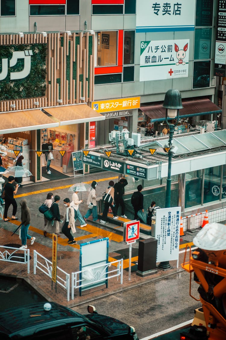 People At Subway Entrance In City In Japan