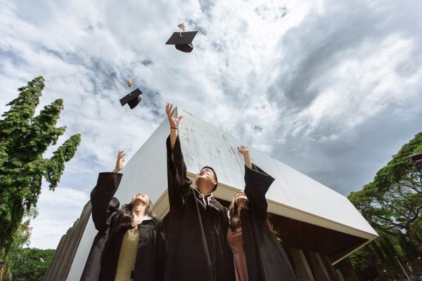Graduates tossing their caps in the air outdoors — photo by Denniz Futalan on Pexels
