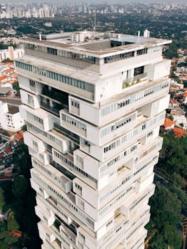 Unique architecture of a modern skyscraper in São Paulo, captured from above.
