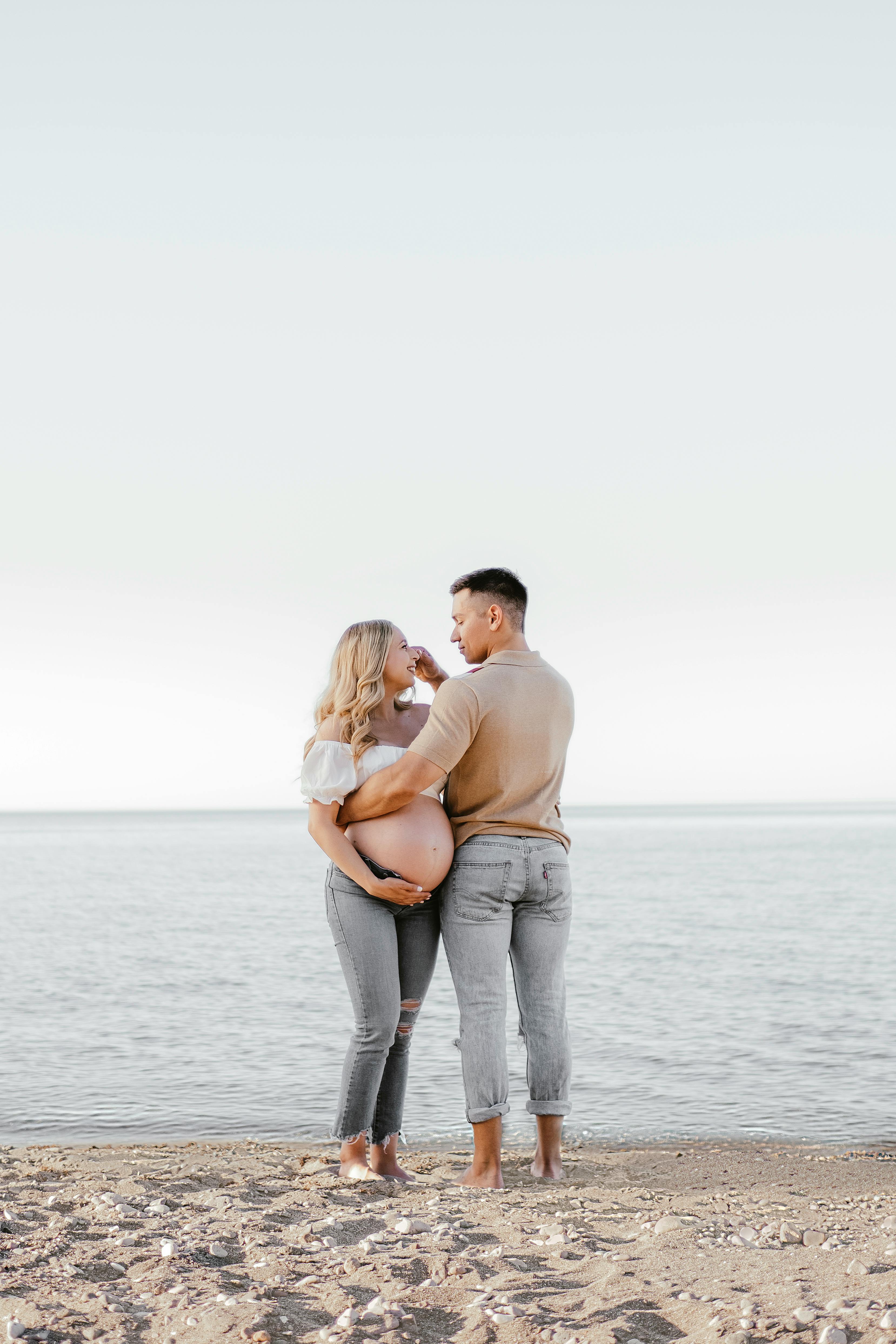 Man and Pregnant Woman on Beach · Free Stock Photo