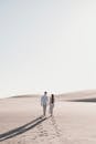 Couple Walking Together on Sunlit Desert
