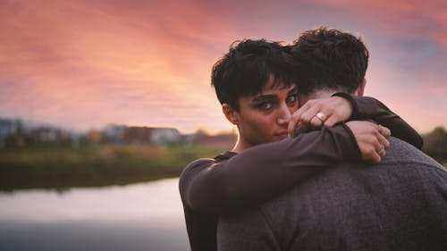 Woman and Man Hugging at Dusk