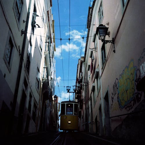 Vintage Tram on Narrow Street in Lisbon
