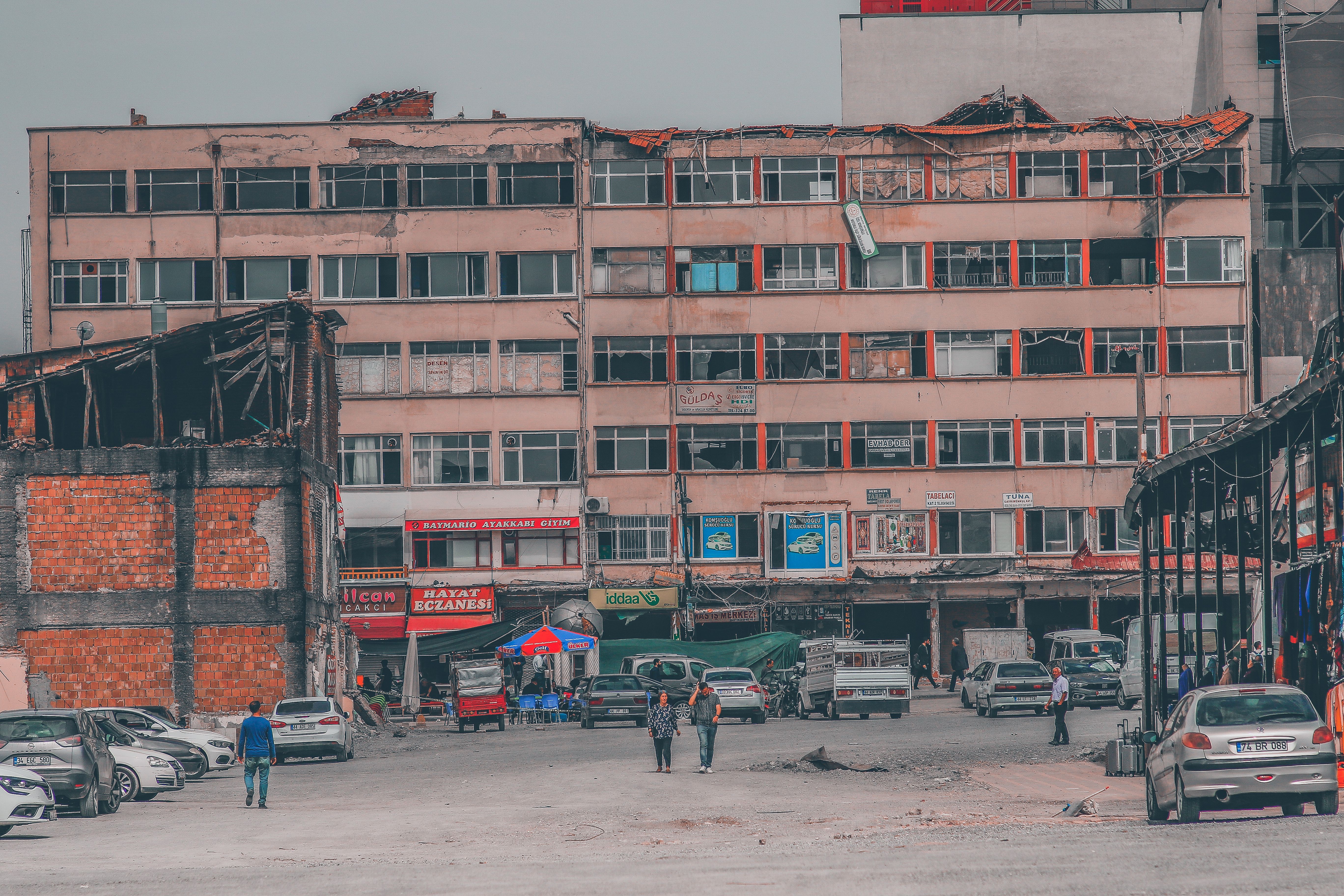 A rundown city block with damaged buildings reflecting urban decline and neglect.