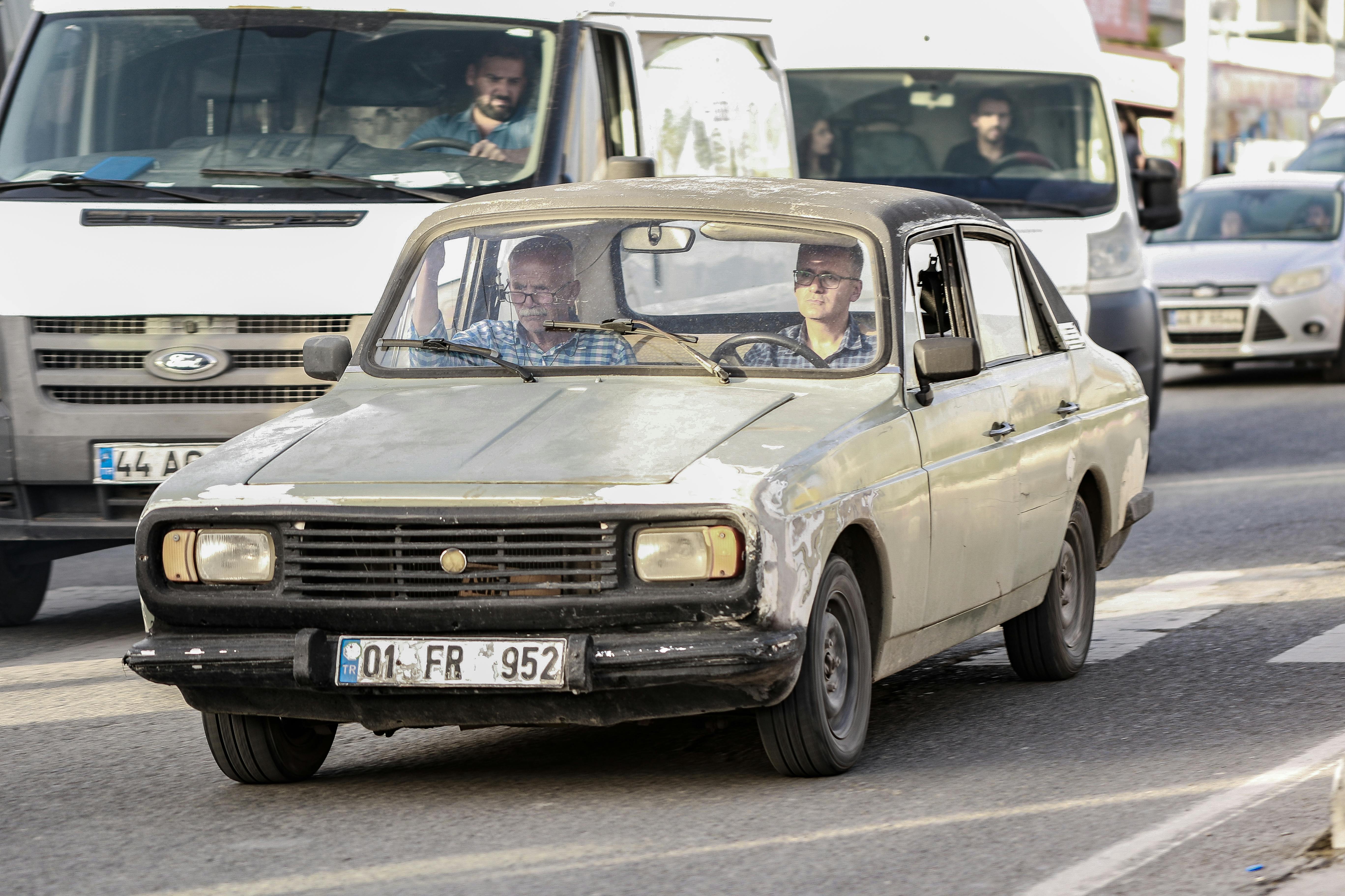 how to drive organic traffic to small business website - Classic vintage car navigating urban streets among modern vehicles.