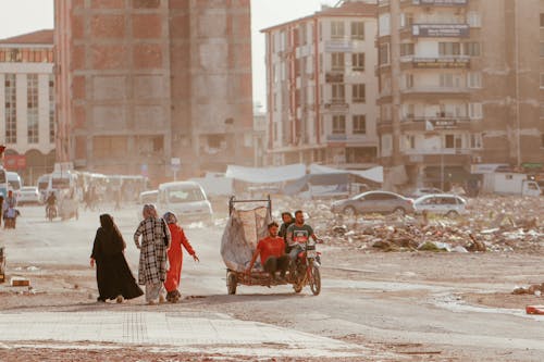 People on Street in Destroyed City