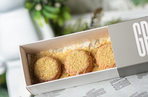Free Close-up of a box with sweet pastries coated in crumbs. Ideal for food photography. Stock Photo