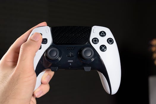 Close-up of a hand holding a modern gaming controller against a dark background.